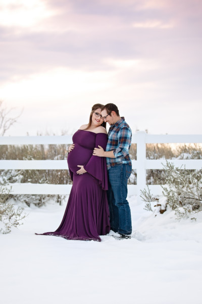 Sweet husband and wife moment during Maternity photo session in the snow in Midland, TX
